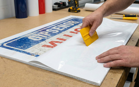 Reapply vinyl over correx with new signage